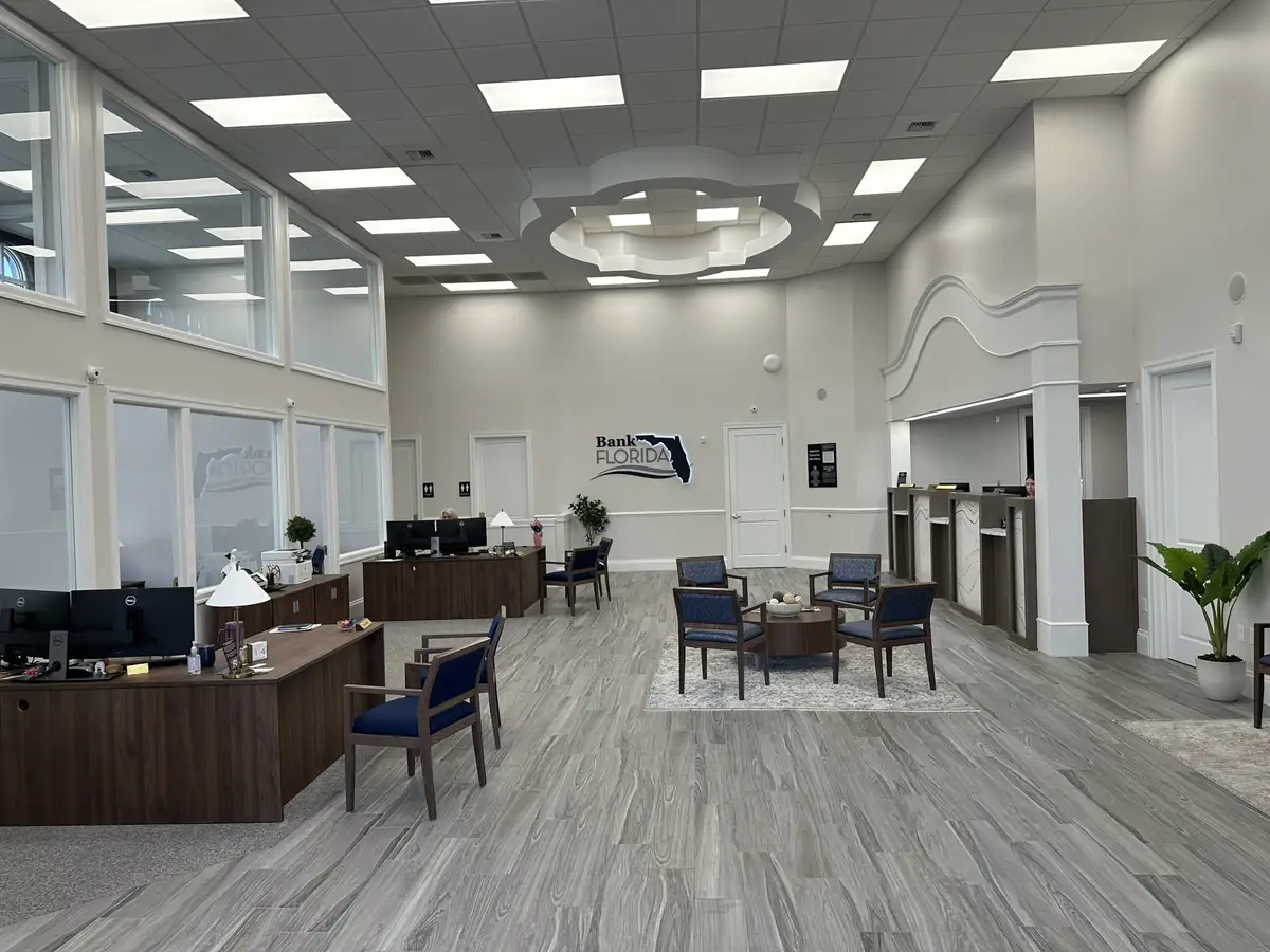 Finished bank lobby with a teller line and seating area
