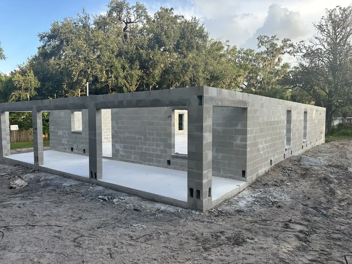 Completed block shell walls standing on a new slab