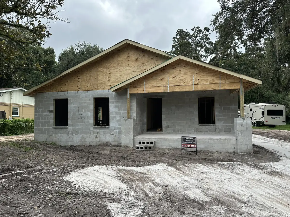 Custom home at dry-in with block walls up and the front gable framed