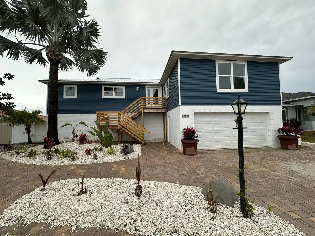 Coastal home with the living level raised above flood elevation and an exterior stair to the entry