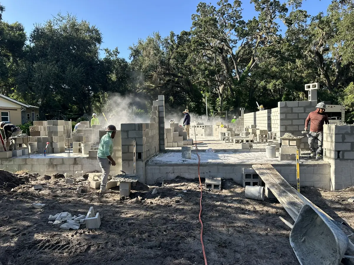 Masons laying block on a new foundation